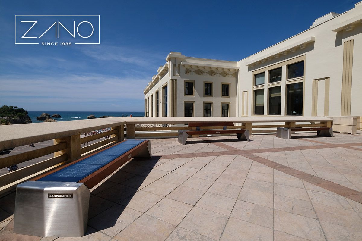 Photon solar benches made of stainless steel and exotic iroko wood in teak stain